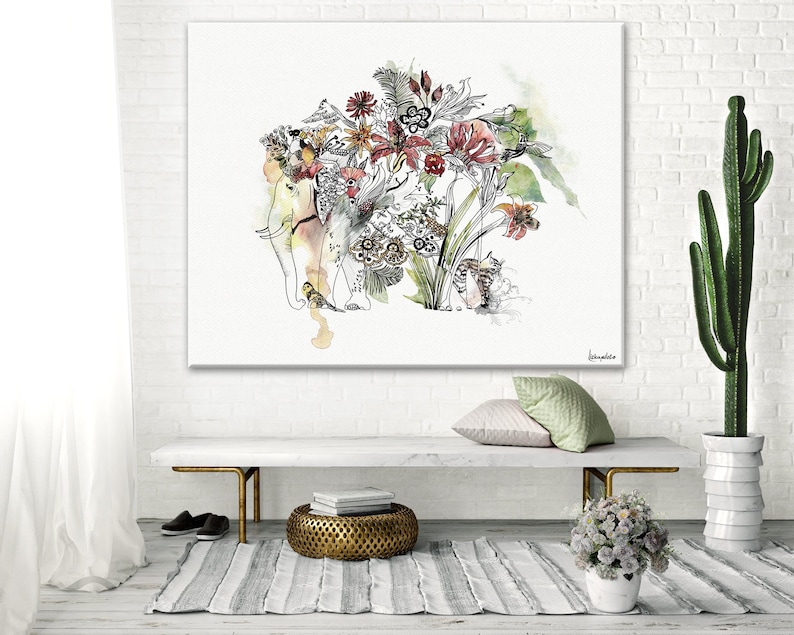 A watercolor painting on canvas featuring an elephant with floral and botanical elements. The artwork includes shades of red, yellow, and green, with black line art details. The painting is displayed above a bench with a gold metal base.