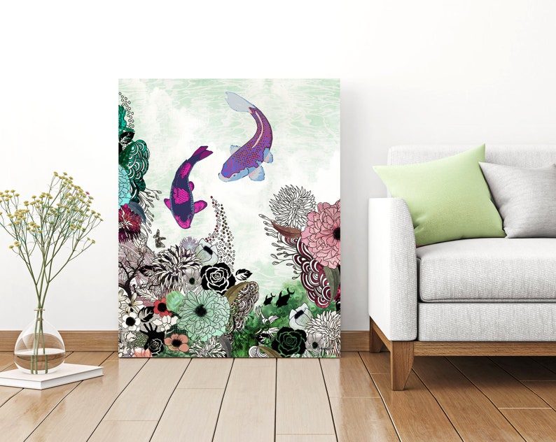 A digital art print featuring two purple and pink koi fish swimming in a green and white floral design. The print is framed and hanging on a white wall.