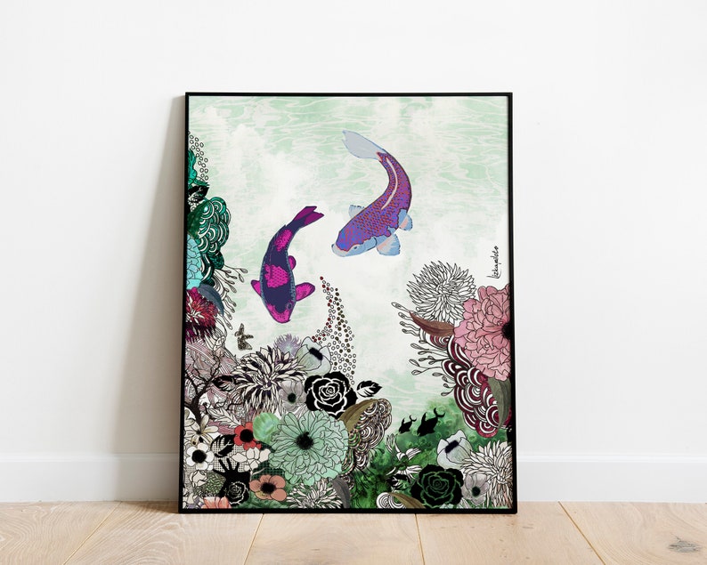 A framed print of a colorful illustration of two koi fish swimming in a pond with a floral background. The fish are purple, pink, and black. The flowers are pink, green, and blue. The background is a light green watercolor wash.