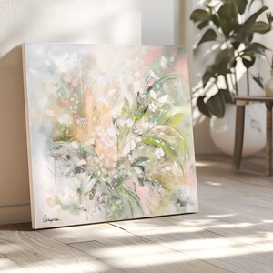 A painting of a bouquet of white flowers with green leaves on a white background. The flowers are painted in a soft, abstract style. The painting is signed in the bottom left corner.