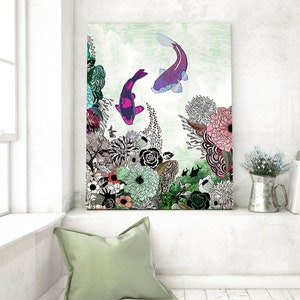A colorful abstract painting of two purple and pink fish swimming in a green and white floral background. The painting is framed and hanging on a white wall.