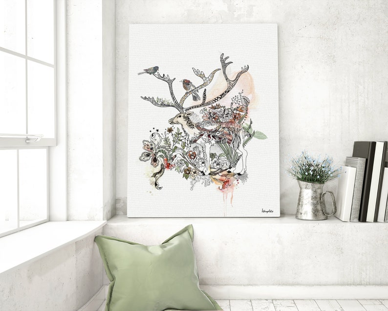 Canvas print featuring a watercolor and ink illustration of a deer surrounded by floral elements and birds. The artwork is predominantly in shades of gray, black, and beige, with accents of orange and pink. The deer is centrally positioned, with its antlers extending outward. The style is whimsical and nature-inspired. The artist's signature is visible in the bottom right corner.