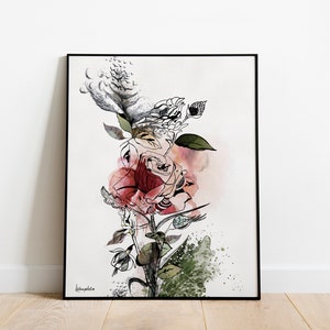 A framed black and white watercolor painting of a pink rose with green leaves and black ink details. The background is a light beige with a watercolor wash of pink and green.