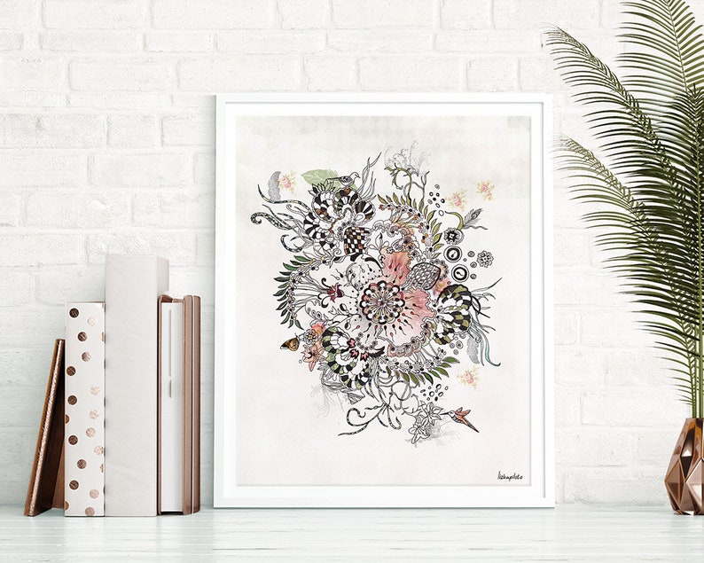 A framed print of a black and white ink drawing of a stylized flower with pink accents on a light gray background. The artist's signature is in the bottom right corner of the print. The print is framed in a white frame.
