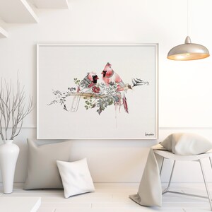 A watercolor painting of two red cardinals perched on a branch with green leaves and white flowers. The birds are facing each other and appear to be interacting. The background is a light gray.