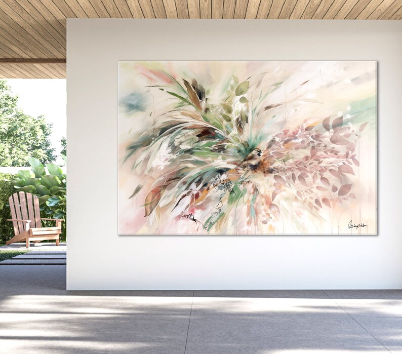Abstract watercolor painting of a floral arrangement in shades of green, brown, pink, and white. The painting is displayed on a white wall in a modern setting.