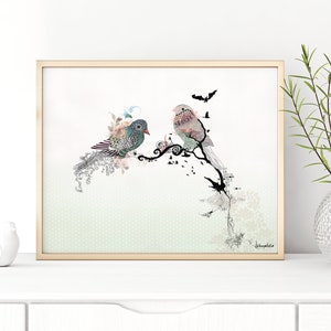 A framed print of two stylized birds perched on a branch with black and white floral accents. The background is a light green with a subtle pattern. The print is signed "K.Humphries".