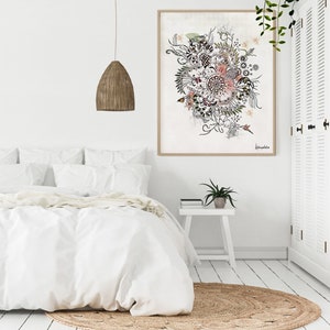 A white bedroom with a white bed, a white nightstand, and a white closet. The bed has a white duvet and a white pillow. The nightstand has a plant on it. The closet has a white door with a floral design on it. The wall has a framed print with a floral design on it. The print is titled 'Johanna.' The room is decorated in a minimalist style.
