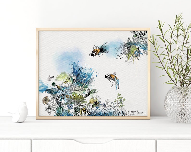 Watercolor painting of two goldfish swimming in a blue and green underwater scene with floral details. The painting is framed in a light wood frame.