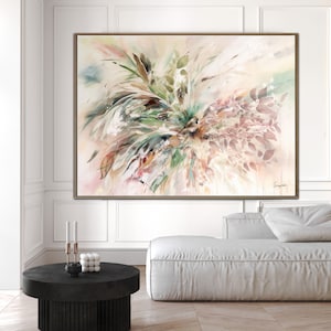 A large abstract painting with a light pink background. The painting features a large cluster of green and brown leaves in the center, with a few pink leaves scattered around the edges. The painting is framed in a light brown frame.