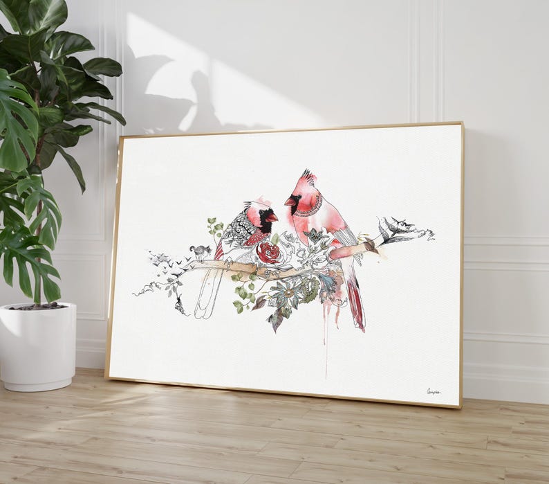 A framed horizontal wall art print featuring a watercolor illustration of two red cardinal birds perched on a branch. The birds are surrounded by detailed black ink line drawings of various flowers, leaves, and vines on a white background.