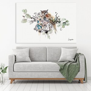 A watercolor painting of an owl perched on a branch with leaves and flowers. The owl is brown and white with large, dark eyes. The painting is on a white background.