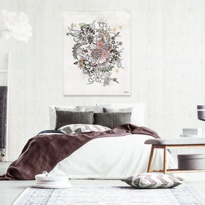 A white bed with a brown blanket and pillows. The bed is in a bedroom with a white wall and a white rug. There is a painting of a floral design on the wall above the bed. A wooden bench is in the foreground with a gray storage box on the bottom shelf.