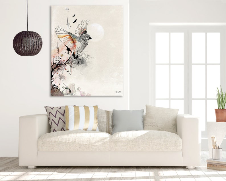 A white canvas print with a watercolor-style illustration of a bird in flight. The bird is gray and white with orange accents and is surrounded by delicate floral details. The background is a soft, muted gray.