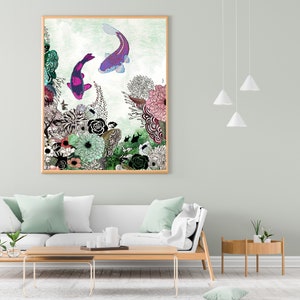 A framed print of a colorful illustration of koi fish swimming in a garden with pink, green, and white flowers. The print is hanging on a light green wall above a white couch with light green throw pillows.