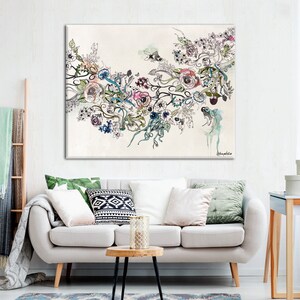 May include: A large canvas art print featuring a floral design with roses, leaves, and abstract elements in shades of pink, blue, and green. The artwork is set against a cream-colored background, creating a soft and elegant aesthetic. The print is displayed in a living room setting.