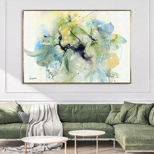 Abstract watercolor painting featuring a large, colorful floral arrangement in shades of blue, green, and yellow. The painting has a soft, ethereal feel and is perfect for adding a touch of nature to any room.