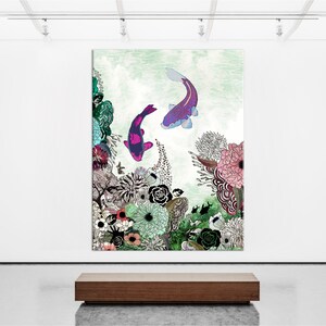 A painting of two purple and pink koi fish swimming in a green and blue water with a floral background. The flowers are in shades of pink, red, green, and blue. The painting is framed and hanging on a white wall.