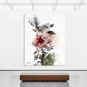 A black and white abstract painting of a rose with pink and red watercolor accents. The painting is displayed in a gallery setting on a white wall with a wooden bench in the foreground.