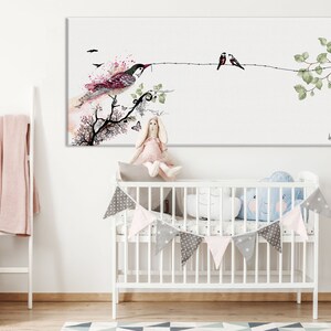 A watercolor painting of birds on a branch hangs above the crib.