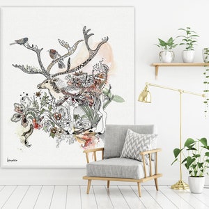 Canvas art print featuring a detailed ink drawing of a reindeer surrounded by floral elements and birds. The artwork is predominantly black and white with accents of soft orange and red watercolor washes. The reindeer is intricately detailed, and the flowers and birds add to the whimsical nature of the piece. The style is reminiscent of botanical illustrations with a touch of whimsy. The overall color palette is soft and muted, creating a serene and calming atmosphere.