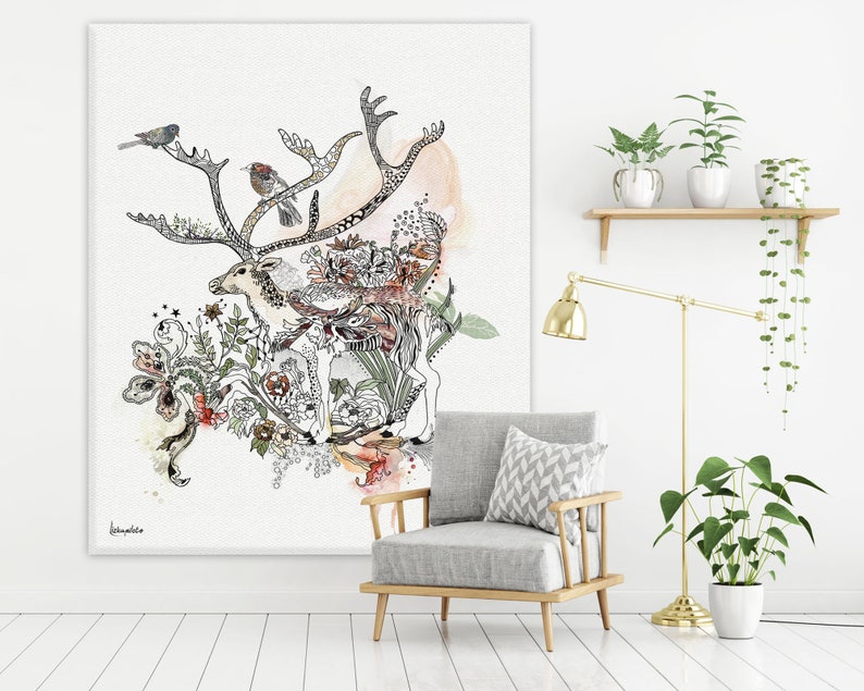 Canvas art print featuring a detailed ink drawing of a reindeer surrounded by floral elements and birds. The artwork is predominantly black and white with accents of soft orange and red watercolor washes. The reindeer is intricately detailed, and the flowers and birds add to the whimsical nature of the piece. The style is reminiscent of botanical illustrations with a touch of whimsy. The overall color palette is soft and muted, creating a serene and calming atmosphere.