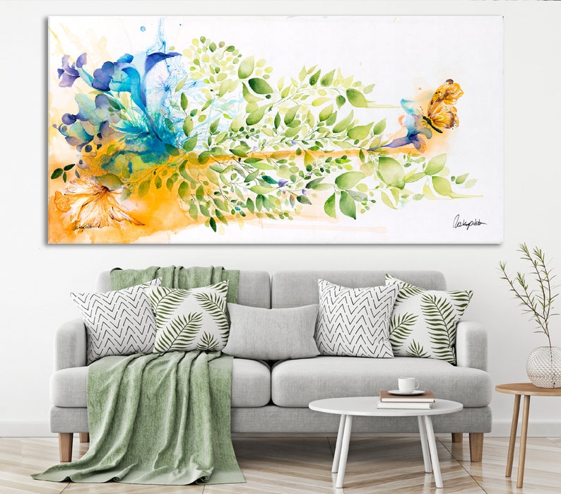 Abstract watercolor painting of a butterfly with green leaves and blue and yellow flowers on a white background.