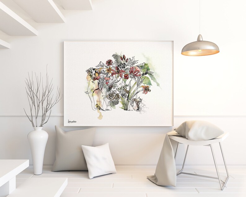 Watercolor art print featuring an elephant adorned with a floral arrangement. The artwork showcases a mix of red, yellow, and green flowers with intricate black line details. The print is framed and displayed in a modern, minimalist interior setting.