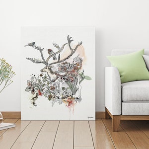 Canvas print featuring a detailed ink drawing of a reindeer surrounded by floral elements and birds. The reindeer is depicted in black ink with subtle watercolor washes of peach and beige. The floral elements are intricate and detailed, with a mix of leaves, flowers, and butterflies in varying shades of brown, green, and pink. Three small birds are perched on the reindeer's antlers. The overall style is whimsical and nature-inspired, with a touch of bohemian flair.
