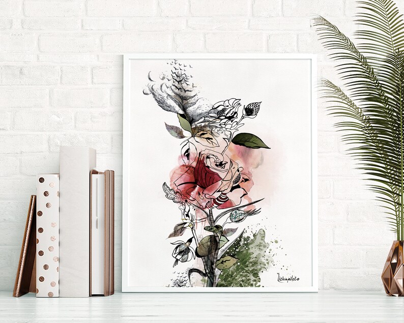 A white framed print of a watercolor painting of a pink and red rose with green leaves and black ink details. The signature 'Rebeccamilito' is in the bottom right corner.