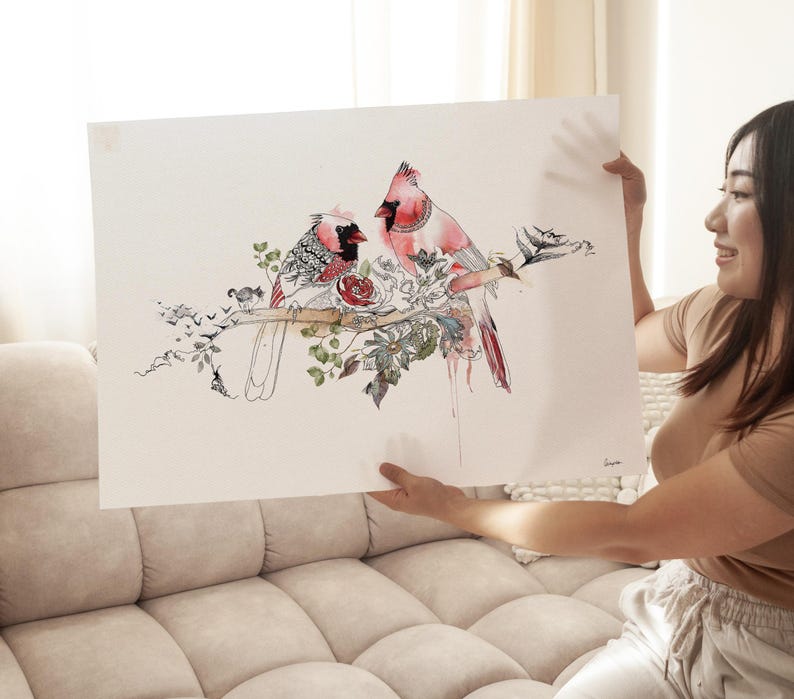 A rectangular art print featuring a detailed watercolor and ink illustration of two red cardinal birds perched on a branch. The birds are surrounded by intricate floral patterns, green leaves, and small black bird silhouettes.