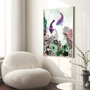 framed print of a colorful illustration of two fish swimming in a floral arrangement. The fish are purple and blue with pink accents. The flowers are a variety of colors including pink, purple, green, and yellow. The background is a light green color.