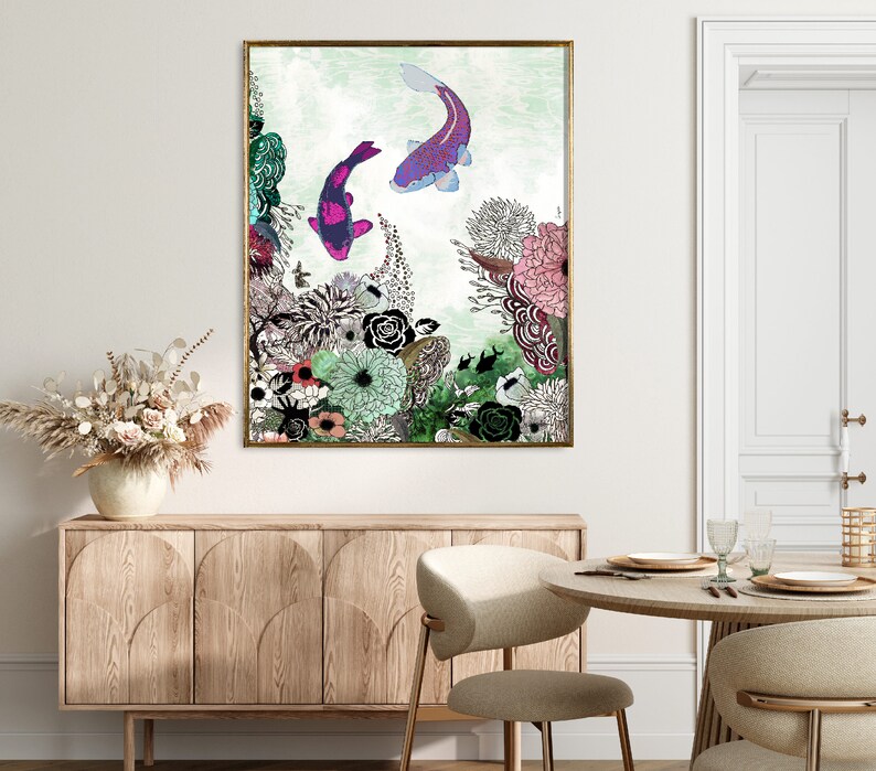 A framed print of a watercolor painting featuring two pink and purple koi fish swimming in a green and blue water with a floral background.