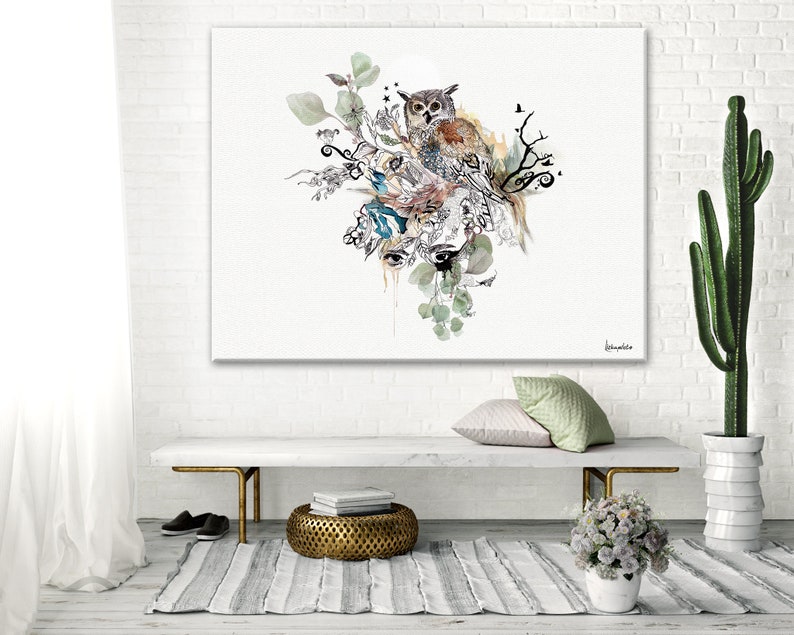 A watercolor painting of an owl perched on a branch with green leaves and flowers. The owl is brown and white with black eyes. The painting is on a white canvas with a white background. The painting is hanging on a white brick wall above a white bench with a gold metal base. There is a small potted plant with white flowers on the bench. There is a cactus plant in a white pot on the right side of the image. The painting is signed 'devandelle' in the bottom right corner.