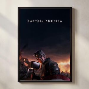 May include: Framed Captain America poster featuring the character holding a hammer and shield, with the text "CAPTAIN AMERICA" at the top. The background shows a fiery, war-torn scene. The poster is in a black frame.