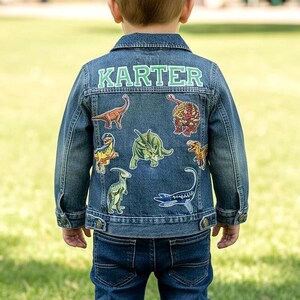 May include: A white ceramic mug with a black handle and the text "But First, Coffee" in a handwritten style. The mug is on a white surface. The mug is approximately 4 inches tall.