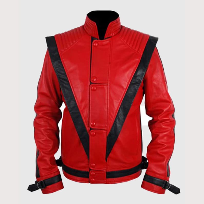 May include: A bright red leather jacket featuring bold black V-shaped panels across the chest and shoulders. The jacket includes a high collar, ribbed shoulder detailing, a front button closure, and black buckled straps at the cuffs and waist.