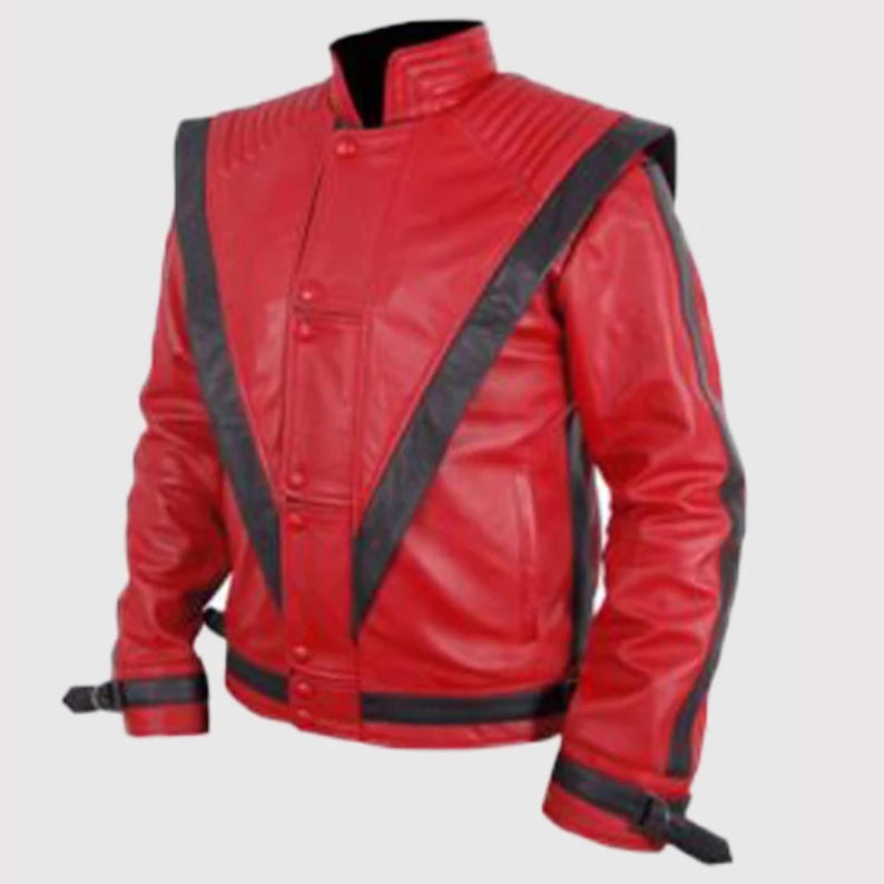 May include: A bright red leather jacket featuring black V-shaped panels extending from the shoulders to the waist. The jacket includes a high collar, ribbed shoulder detailing, a front button closure, and black buckled straps at the cuffs.