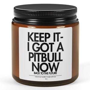 May include: A brown glass jar with a black lid. The jar has a white label with the text "KEEP IT - I GOT A PITBULL NOW" in bold black letters. Below the text is "BACK TO THE FUTURE".