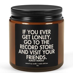 May include: A brown glass jar with a black lid. The jar has a label with the text "IF YOU EVER GET LONLEY, GO TO THE RECORD STORE AND VISIT YOUR FRIENDS." The text "ALMOST FAMOUS" is also on the label.