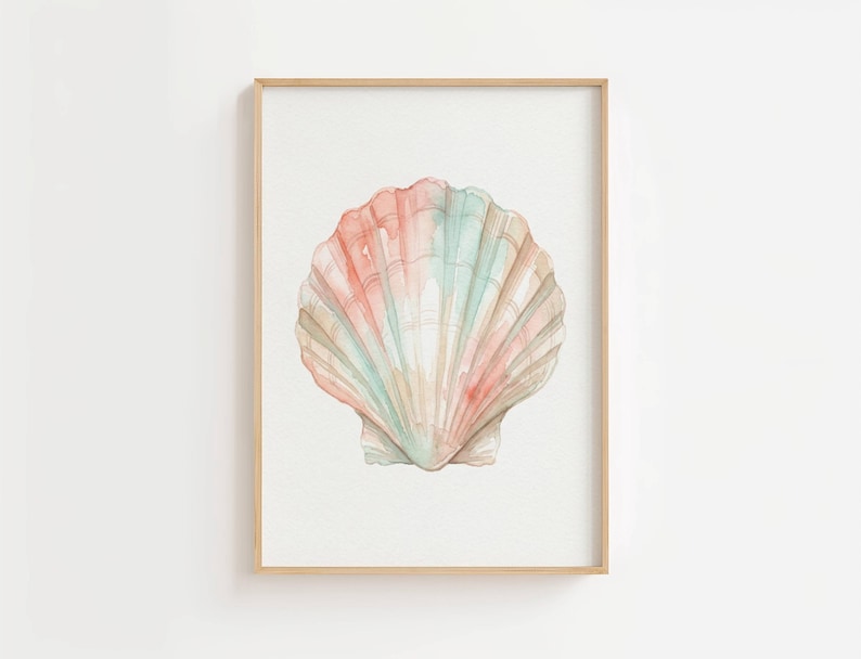 May include: A framed watercolor print featuring a single scallop shell centered on a white background. The shell displays soft, blended washes of pastel pink, peach, and mint green, with defined vertical ridges and a light wooden frame.