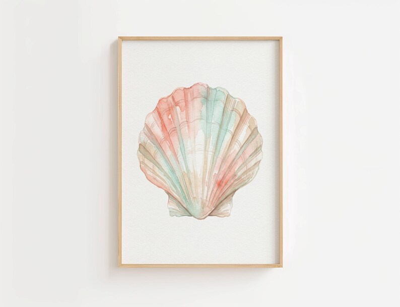 May include: A framed watercolor print featuring a single scallop shell centered on a white background. The shell displays soft, blended washes of pastel pink, peach, and mint green, with defined vertical ridges and a light wooden frame.