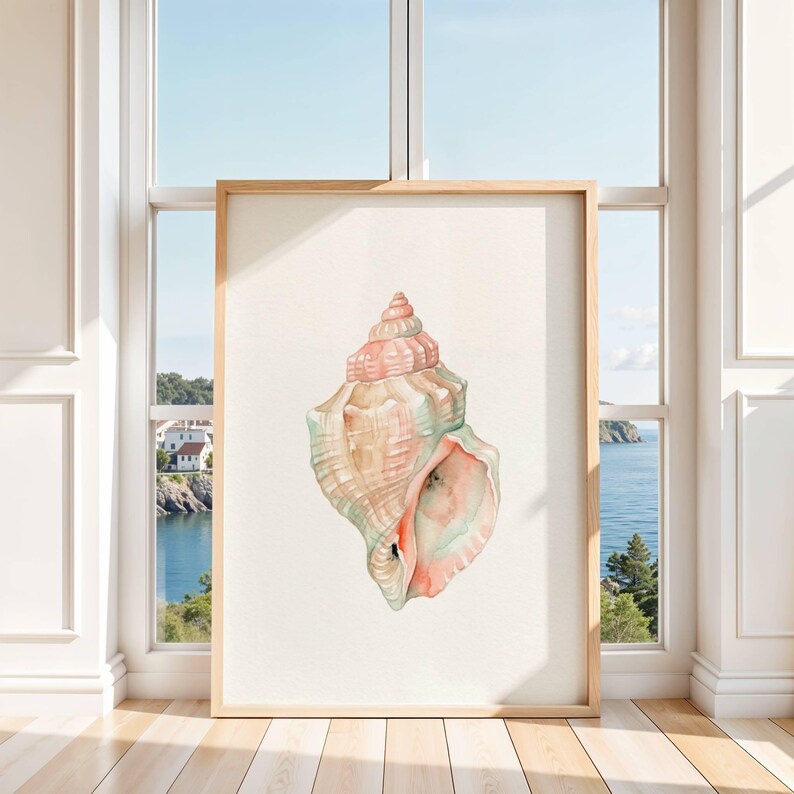 May include: A vertical rectangular framed print featuring a watercolor illustration of a single seashell. The shell displays a spiral structure with soft pastel pink, peach, and light green hues against a plain, off-white background.