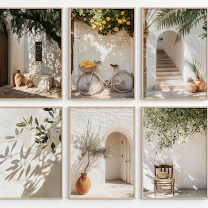 May include: A set of six framed wall art prints featuring Mediterranean scenes. The images display white stone walls, a bicycle with a basket of lemons, terracotta pots, olive branches, a wooden chair with a straw hat, and stone staircases.