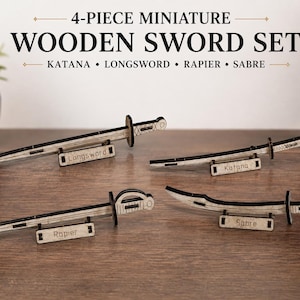 May include: A 4-piece miniature wooden sword set featuring a katana, longsword, rapier, and sabre. Each sword is crafted from light-colored wood with dark edges and rests on a small stand labeled with its respective name. The text reads 4-PIECE MINIATURE WOODEN SWORD SET KATANA • LONGSWORD • RAPIER • SABRE.