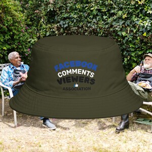 May include: A white ceramic mug with a black handle and the text "But First, Coffee" in a bold, black font. The mug is set against a blurred background, suggesting a cosy setting.