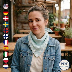 May include: A woman wearing a light blue crocheted scarf with white floral accents. She is wearing a denim jacket. The scarf is a triangular shape. The image includes a "PDF PATTERN" logo.