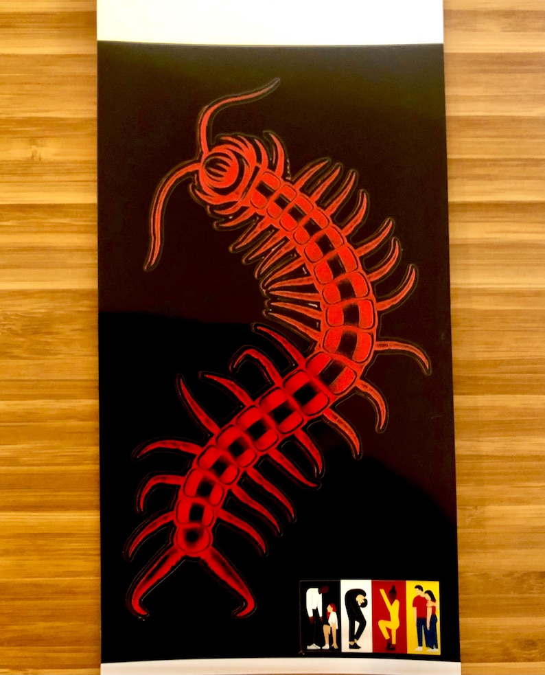 May include: A red centipede illustration on a black background. The centipede is stylized with a detailed, segmented body and multiple legs. The image has a glossy finish and a white border. A small, colorful graphic is at the bottom.