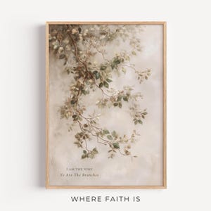 May include: A framed wall art print featuring a delicate illustration of leafy branches in muted green and brown tones against a soft, cream-coloured background. The text "I AM THE VINE Ye Are The Branches" is printed in a simple serif font at the bottom.