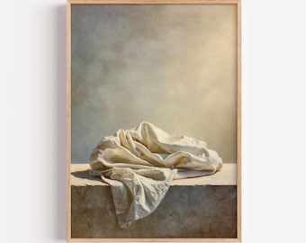 May include: A framed art print featuring a draped, off-white cloth resting on a stone surface. The background has a soft, neutral color palette with a warm, golden light. The text "WHERE FAITH IS" is printed at the bottom.